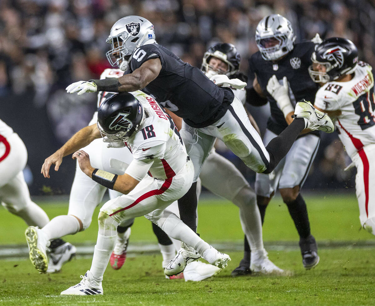 Atlanta Falcons quarterback Kirk Cousins (18) is taken down after a rushed pass by Raiders line ...