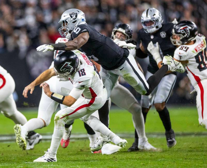 Atlanta Falcons quarterback Kirk Cousins (18) is taken down after a rushed pass by Raiders line ...