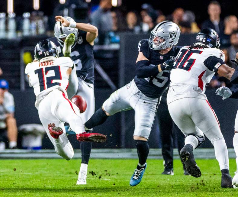 Atlanta Falcons wide receiver KhaDarel Hodge (12) blocks a punt attempt by Raiders punter AJ Co ...