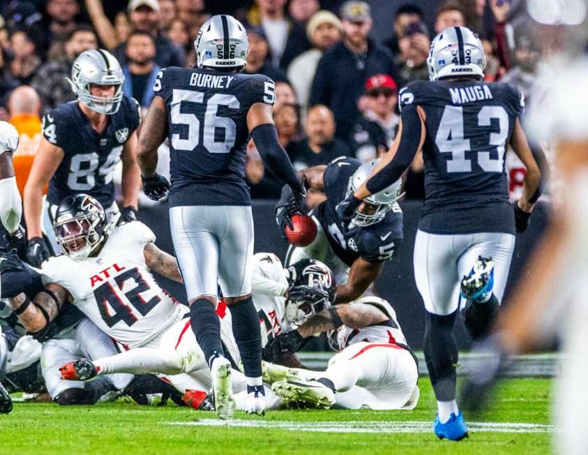 Raiders linebacker Divine Deablo (5) scoops up a blocked punt and nearly gets the first down on ...