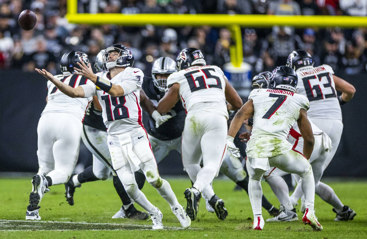 Atlanta Falcons quarterback Kirk Cousins (18) looks to grab a high snap against the Raiders dur ...