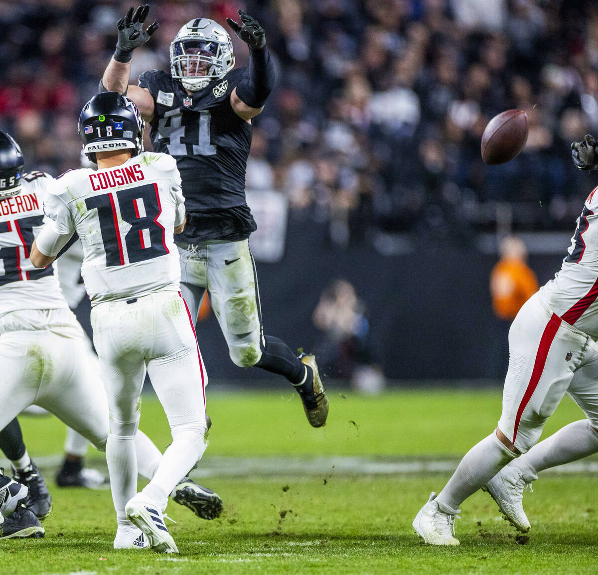 Atlanta Falcons quarterback Kirk Cousins (18) gets off a pass as Raiders linebacker Robert Spil ...