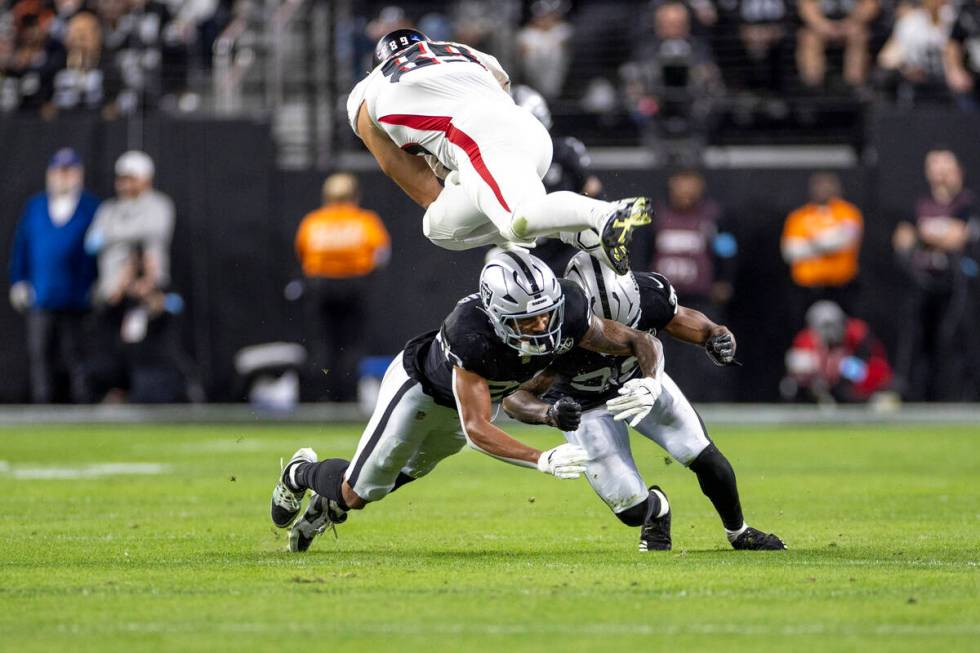 Raiders safety Isaiah Pola-Mao (20) dives after Atlanta Falcons tight end Charlie Woerner (89) ...