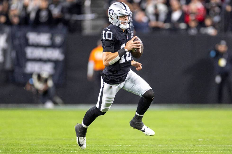 Raiders quarterback Desmond Ridder (10) runs with the ball during the first half of the NFL gam ...