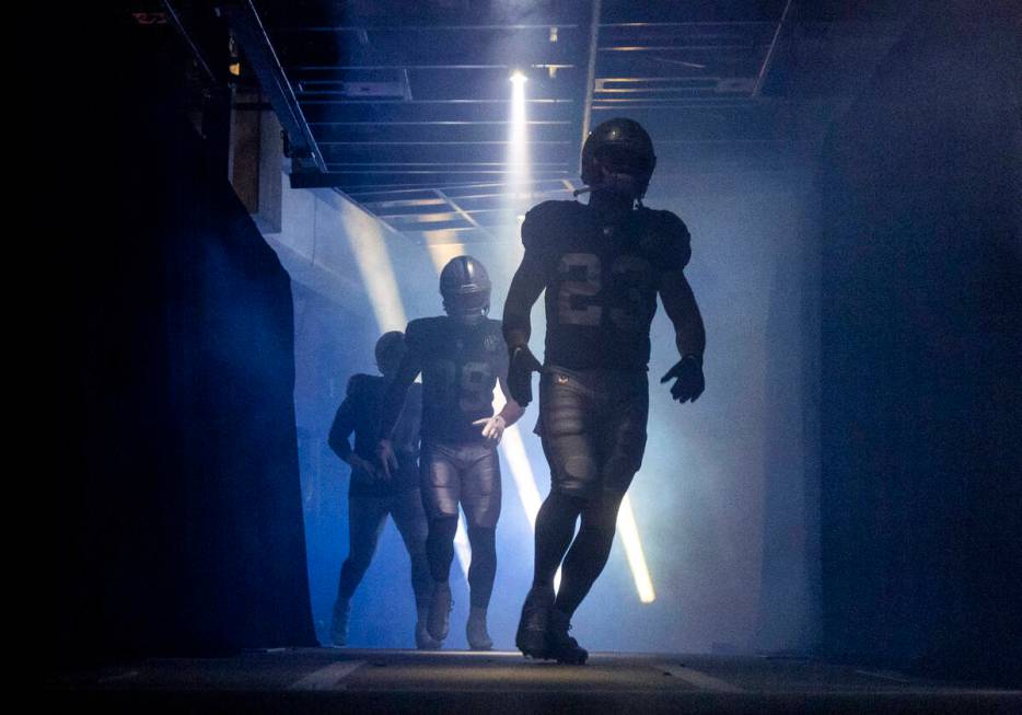 Raiders players run out of the entrance tunnel before the NFL game against the Atlanta Falcons ...