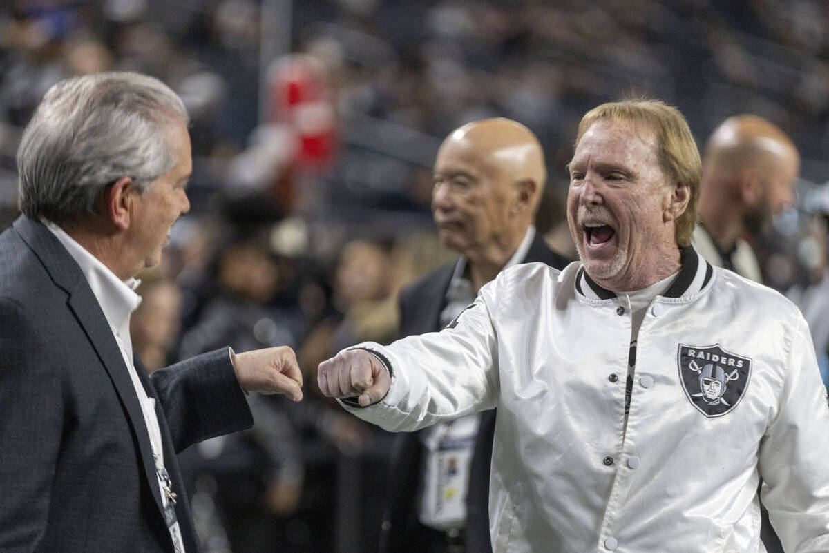 Raiders owner Mark Davis, right, greets an attendee before the start of an NFL game against the ...