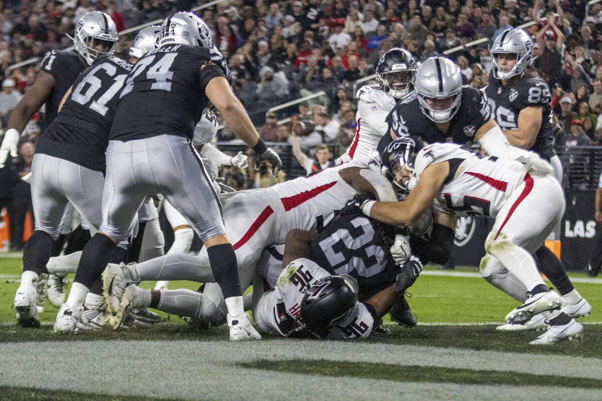 Atlanta Falcons defensive tackle Kentavius Street (93) and defensive end Zach Harrison (96) tac ...