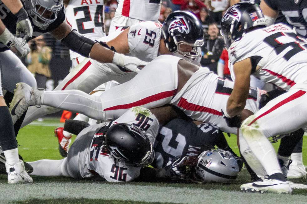 Atlanta Falcons defensive tackle Kentavius Street (93) and defensive end Zach Harrison (96) tac ...