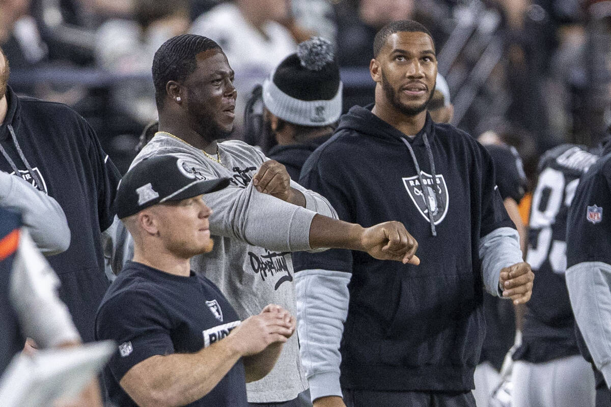 Raiders defensive end Charles Snowden, right, watches the team play against the Atlanta Falcons ...