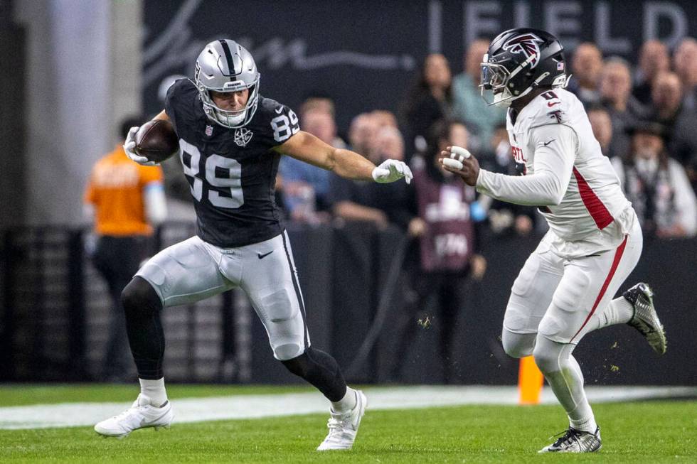 Raiders tight end Brock Bowers (89) runs after the catch with Atlanta Falcons linebacker Lorenz ...