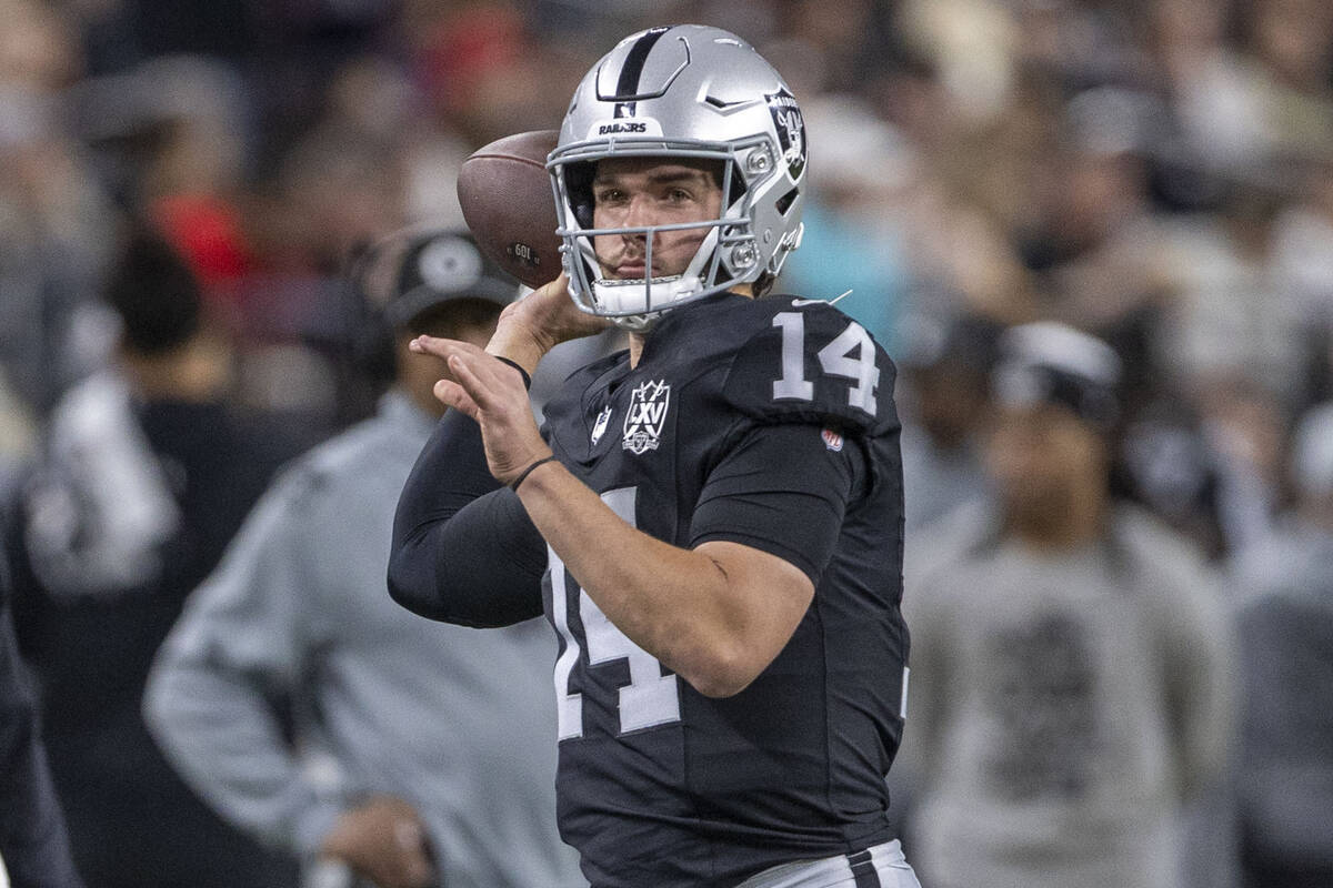 Raiders quarterback Carter Bradley (14) throws the football on the sideline during the first ha ...