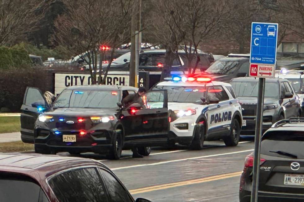 Emergency vehicles are parked outside the Abundant Life Christian School in Madison, Wis., wher ...