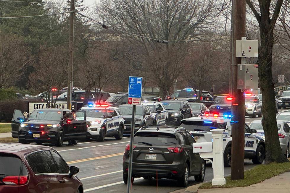 Emergency vehicles are parked outside the Abundant Life Christian School in Madison, Wis., wher ...