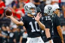 Raiders quarterback Desmond Ridder (10) throws the ball as he warms up prior to an NFL game aga ...