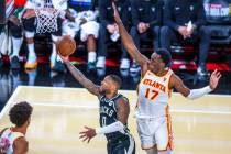 Milwaukee Bucks guard Damian Lillard (0) gets underneath Atlanta Hawks forward Onyeka Okongwu ( ...