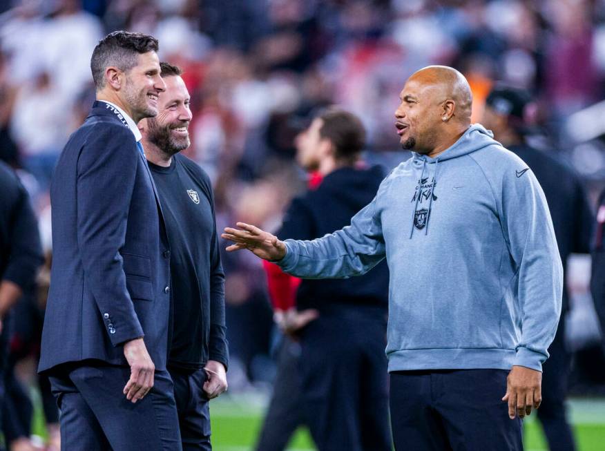 Raiders Head Coach Antonio Pierce talks with others on the field during warm ups before the fir ...