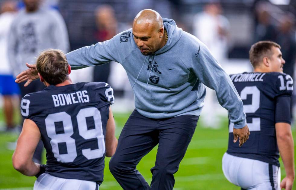 Raiders Head Coach Antonio Pierce greets tight end Brock Bowers (89) during warm ups before the ...