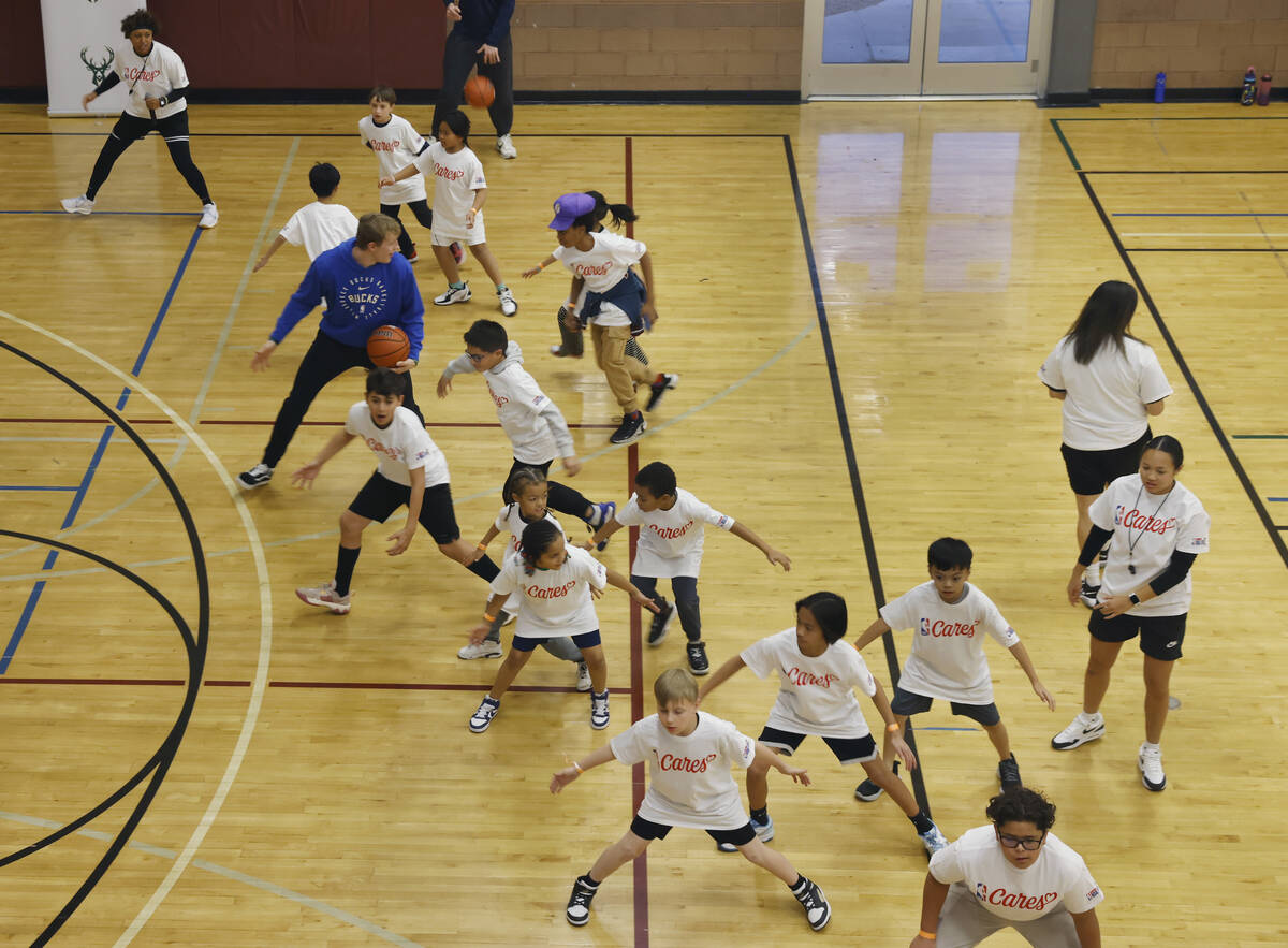 Milwaukee Bucks guard AJ Green, warms up with children during a basketball clinic at Bill and L ...