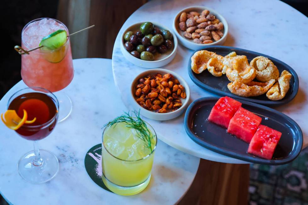 Snacks paired with drinks are seen at Petite Boheme, a new bar by chef James Trees on Dec. 18, ...