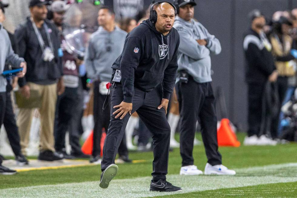 Raiders head coach Antonio Pierce reacts to a play during the first half of an NFL game against ...