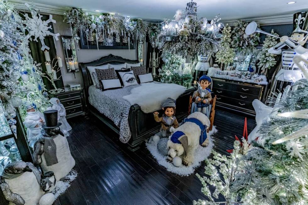 A bedroom showcased 10 flocked trees, animatronic polar bears, white garlands and lights. A thi ...