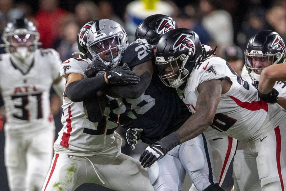 Raiders running back Sincere McCormick (28) is gang tackled by the Atlanta Falcons during the f ...