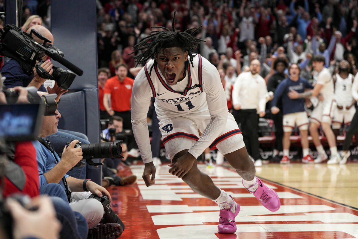 Dayton's Malachi Smith (11) reacts after scoring during the second half of an NCAA college bask ...