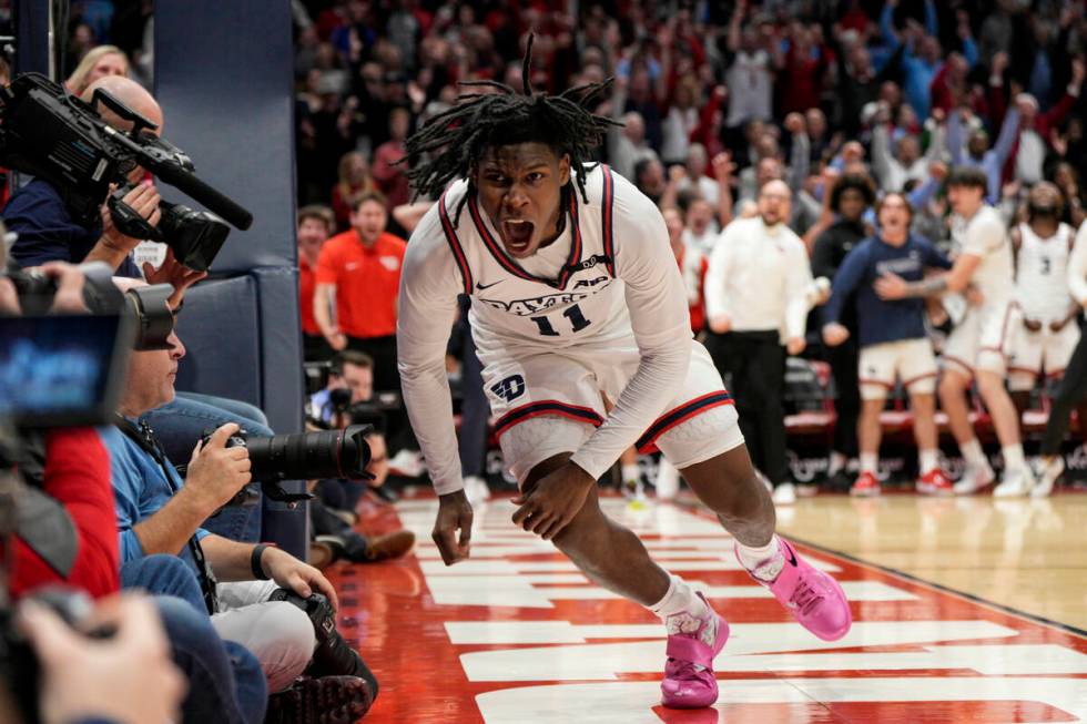 Dayton's Malachi Smith (11) reacts after scoring during the second half of an NCAA college bask ...