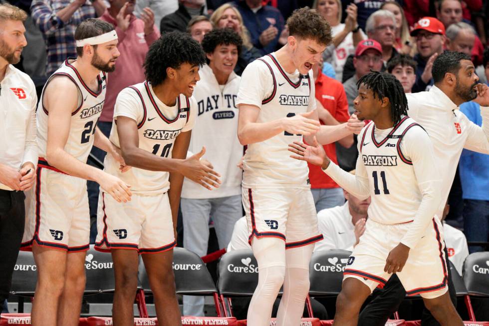 Dayton's Malachi Smith (11) celebrates with teammates after scoring during the second half of a ...