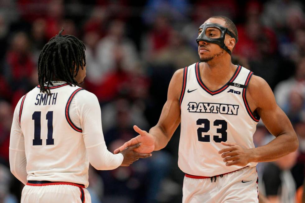 Dayton's Zed Key (23) celebrates with teammate Malachi Smith (11) during the first half of an N ...