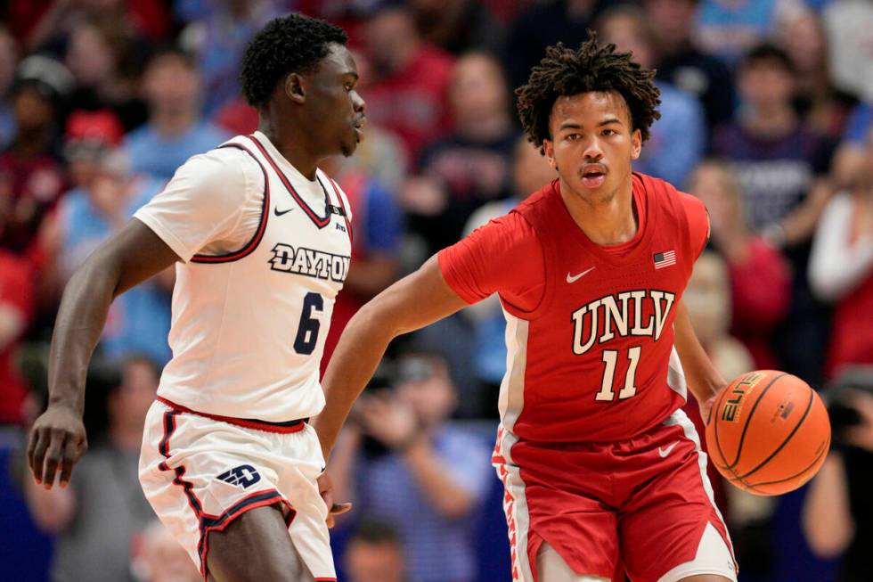 UNLV guard Dedan Thomas Jr. (11) dribbles against Dayton's Enoch Cheeks (6) during the first ha ...