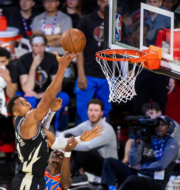 Milwaukee Bucks forward Giannis Antetokounmpo, top, attempts a layup past Oklahoma City Thunder ...