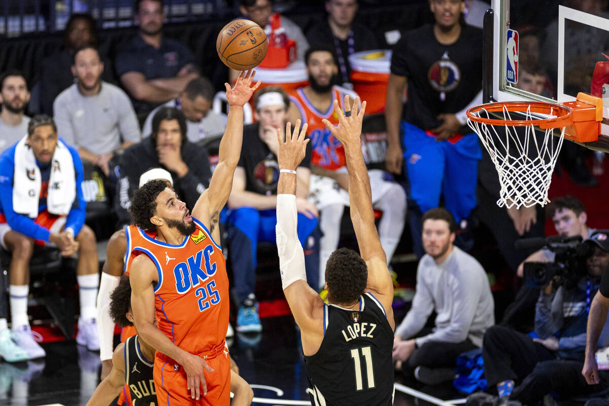 Oklahoma City Thunder guard Ajay Mitchell (25) attempts a layup over Milwaukee Bucks center Bro ...