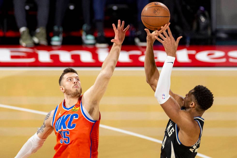 Oklahoma City Thunder center Isaiah Hartenstein (55) attempts to block a shot by Milwaukee Buck ...