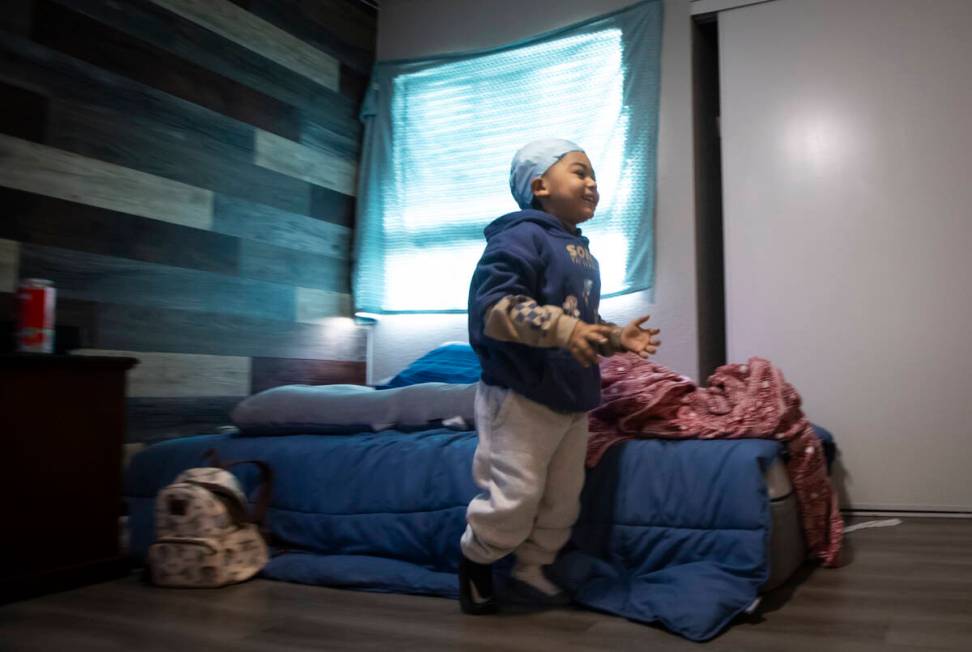 Carmelo Crews, 3, smiles while running past one of the mattresses that was donated to the famil ...