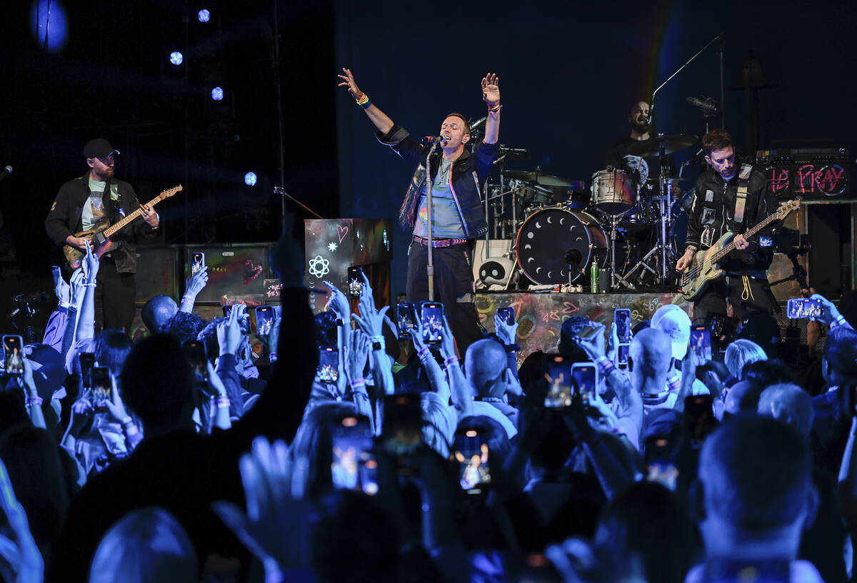 Jonny Buckland, From left, Chris Martin, Will Champion and Guy Berryman of Coldplay perform dur ...