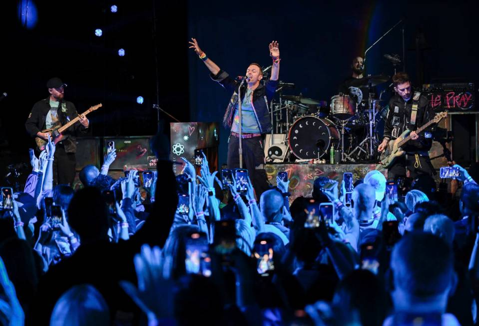 Jonny Buckland, From left, Chris Martin, Will Champion and Guy Berryman of Coldplay perform dur ...