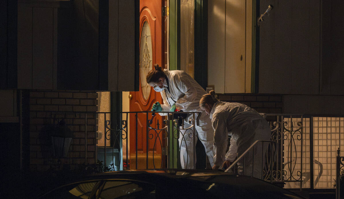 Technicians investigate a crime scene where police say multiple family members were found dead ...