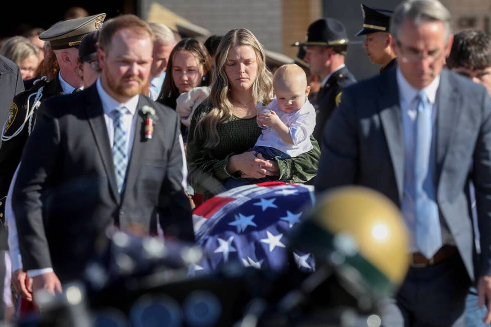 Ashlee Pulsipher, widow of Las Vegas police officer Colton Pulsipher, center, watches the caske ...