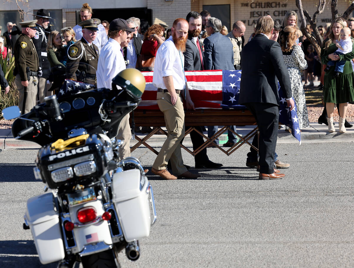 Ashlee Pulsipher, widow of Las Vegas police officer Colton Pulsipher, right, watches the casket ...