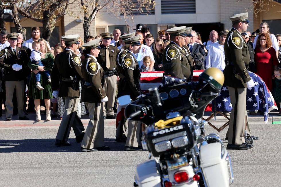 Ashlee Pulsipher, widow of Las Vegas police officer Colton Pulsipher, left, watches the casket ...