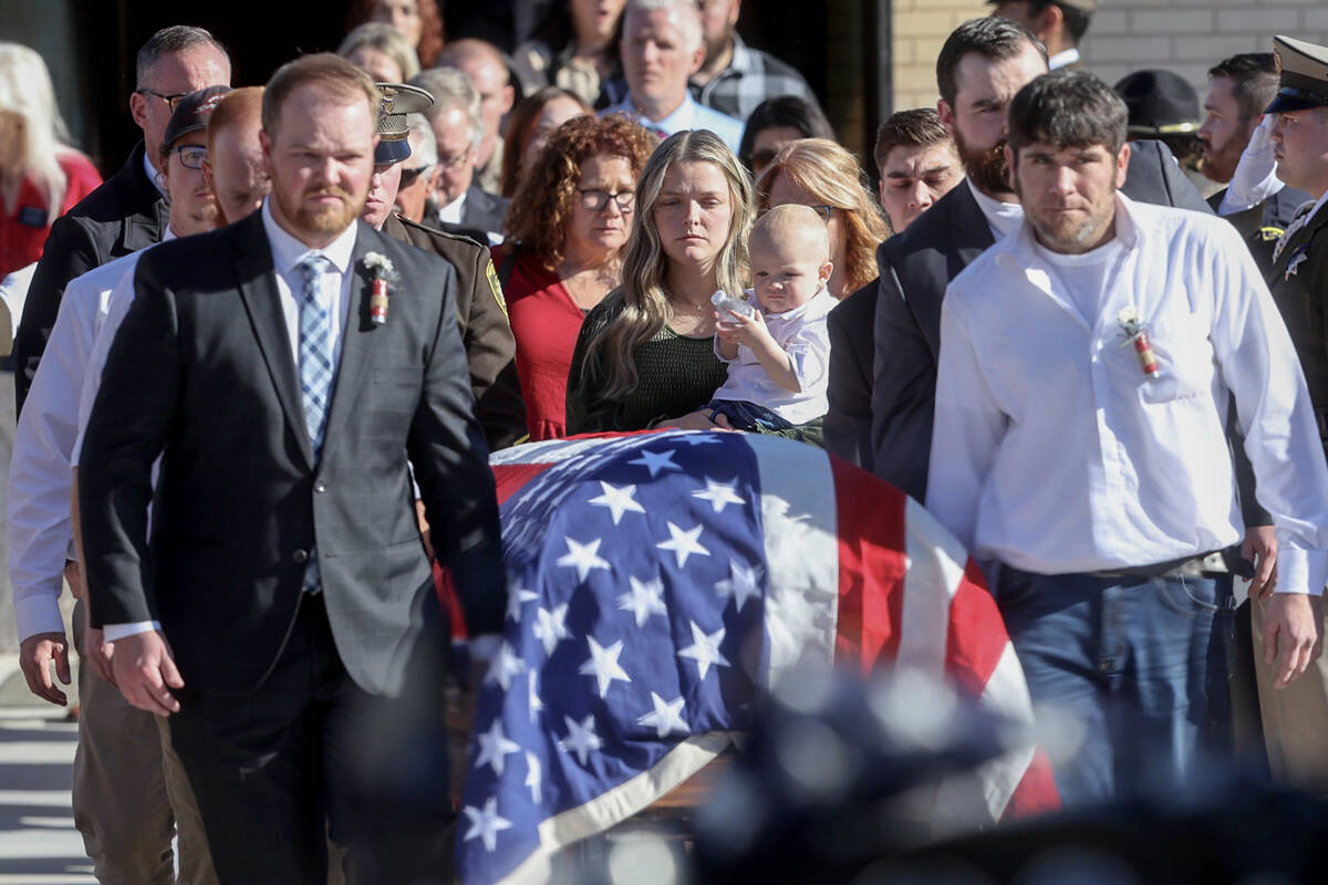 Ashlee Pulsipher, widow of Las Vegas police officer Colton Pulsipher, center, watches the caske ...