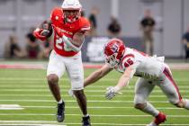 UNLV running back Michael Allen (26) outruns Utah Tech linebacker Spencer Rich (45) during the ...