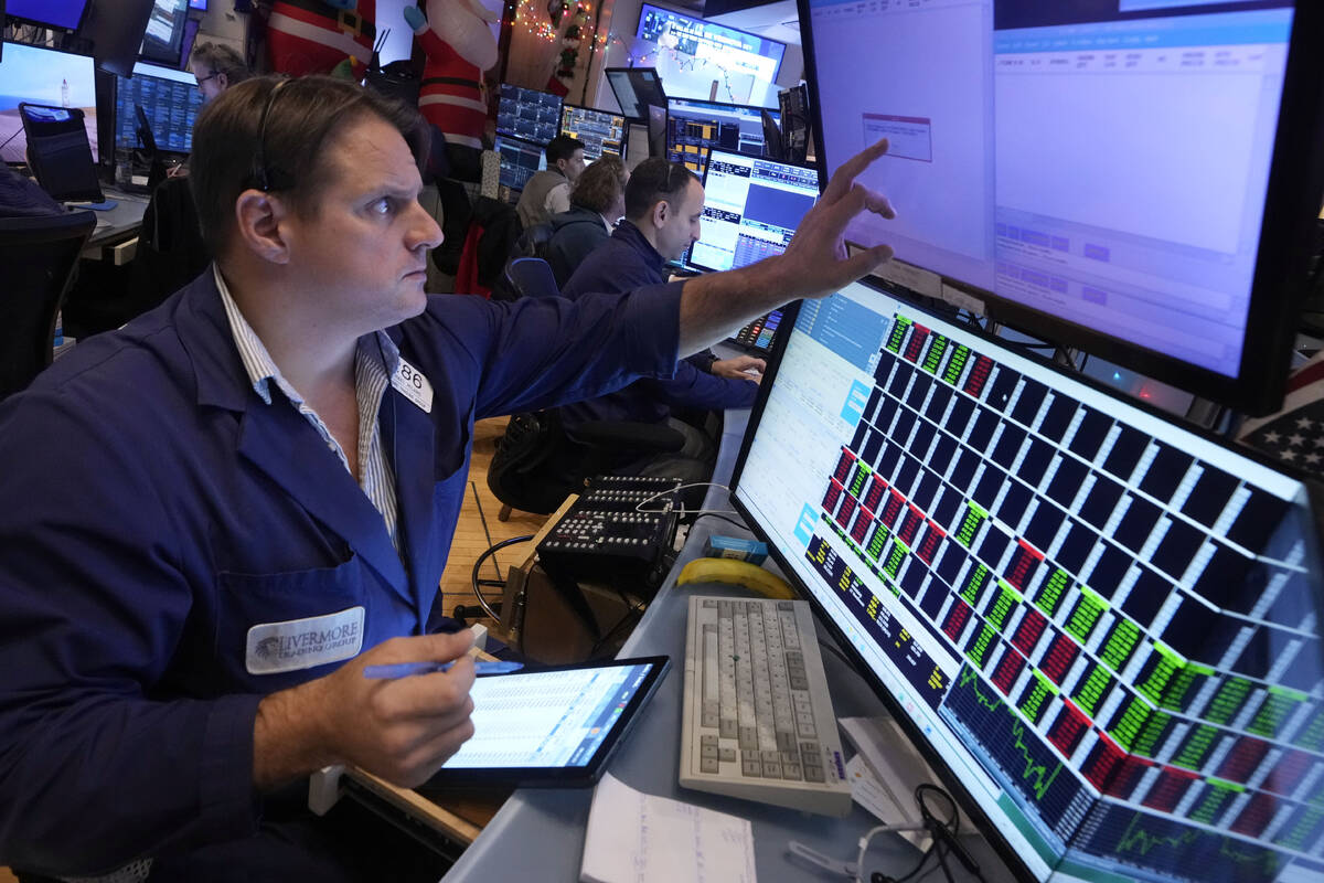 Trader Michael Milano works on the floor of the New York Stock Exchange, Wednesday, Dec. 18, 20 ...