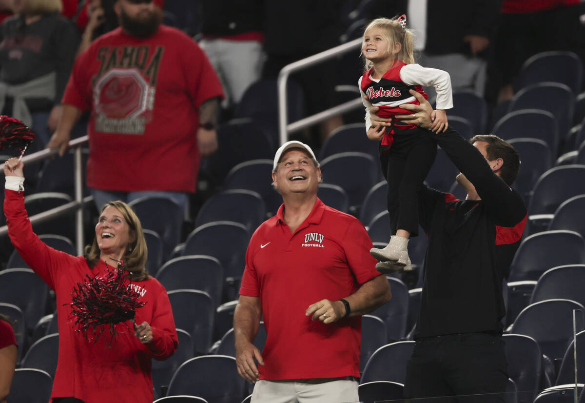 UNLV fans react for a video camera before the start of the LA Bowl NCAA college football game a ...