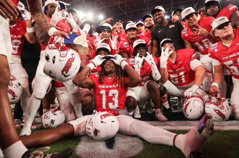 UNLV defensive back Jarvis Ware (13) puts on a hat after defeating Cal in the LA Bowl at SoFi S ...