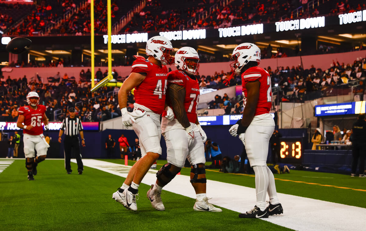 UNLV running back Kylin James, right, celebrates his touchdown with offensive lineman Mathyus S ...