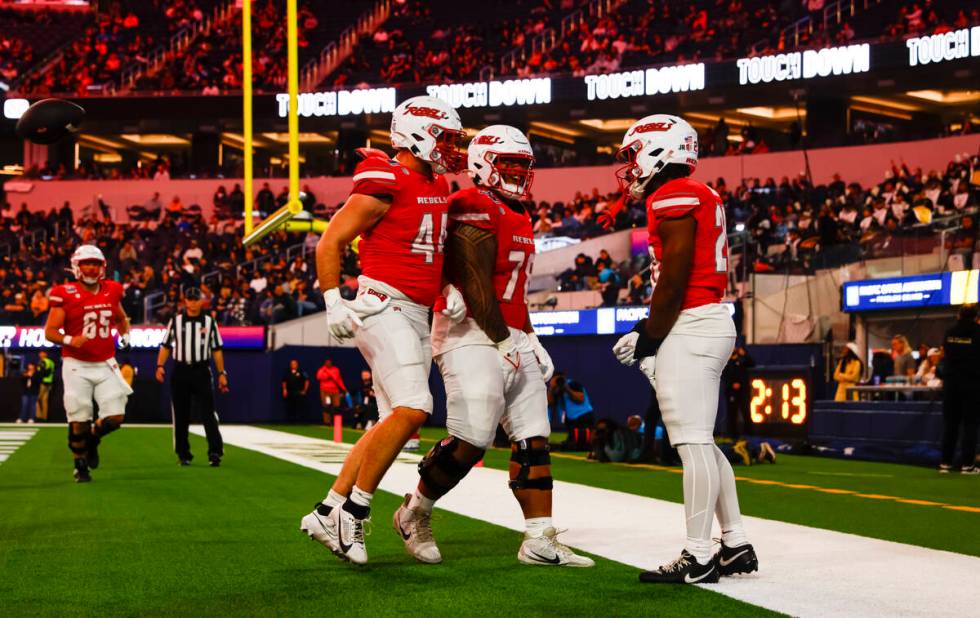 UNLV running back Kylin James, right, celebrates his touchdown with offensive lineman Mathyus S ...