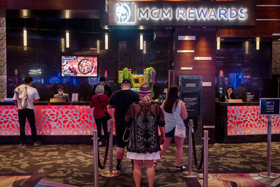 People wait in line at the MGM Rewards desk at the Aria hotel-casino on Friday, June 17, 2022, ...