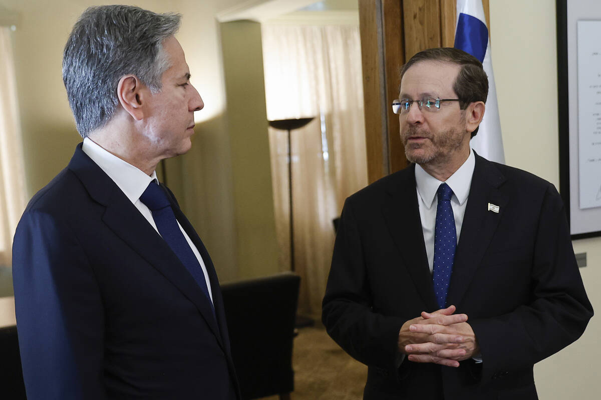 FILE- U.S. Secretary of State Antony Blinken, left, speaks with Israeli President Isaac Herzog, ...